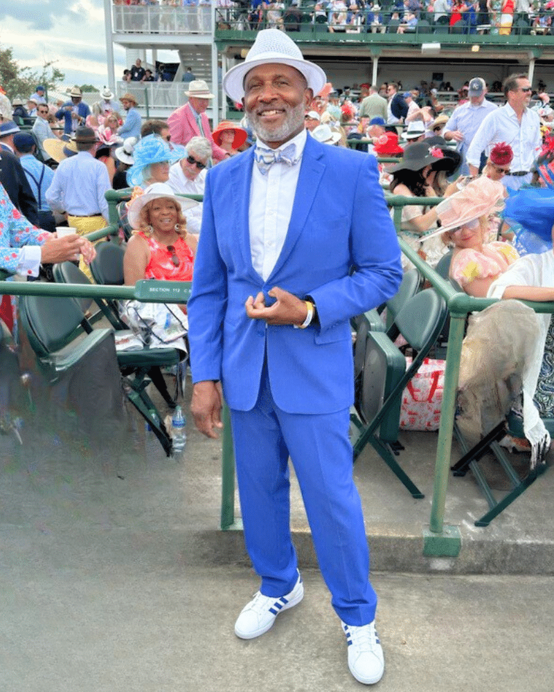 Ken Alexander dressed for the Kentucky Derby in a bright blue suit and white hat, looking stylish and confident.