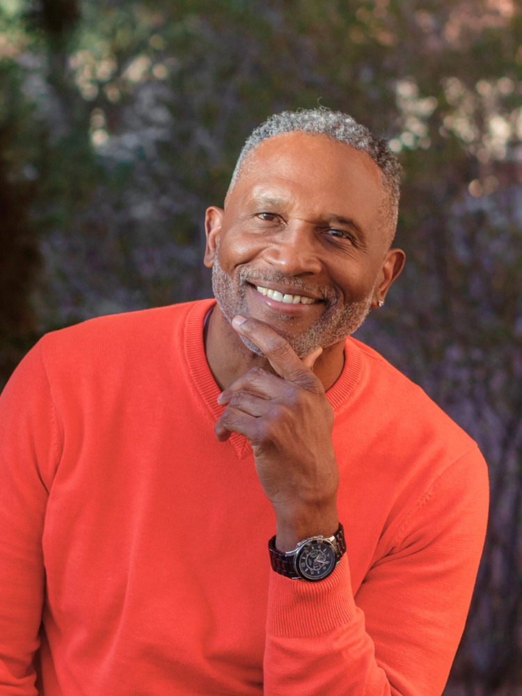 Kenneth G Alexander author of The Deep End blog in an orange sweater.